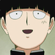 Mob, the lead character of Mob Psycho 100, looking excited and smiling.